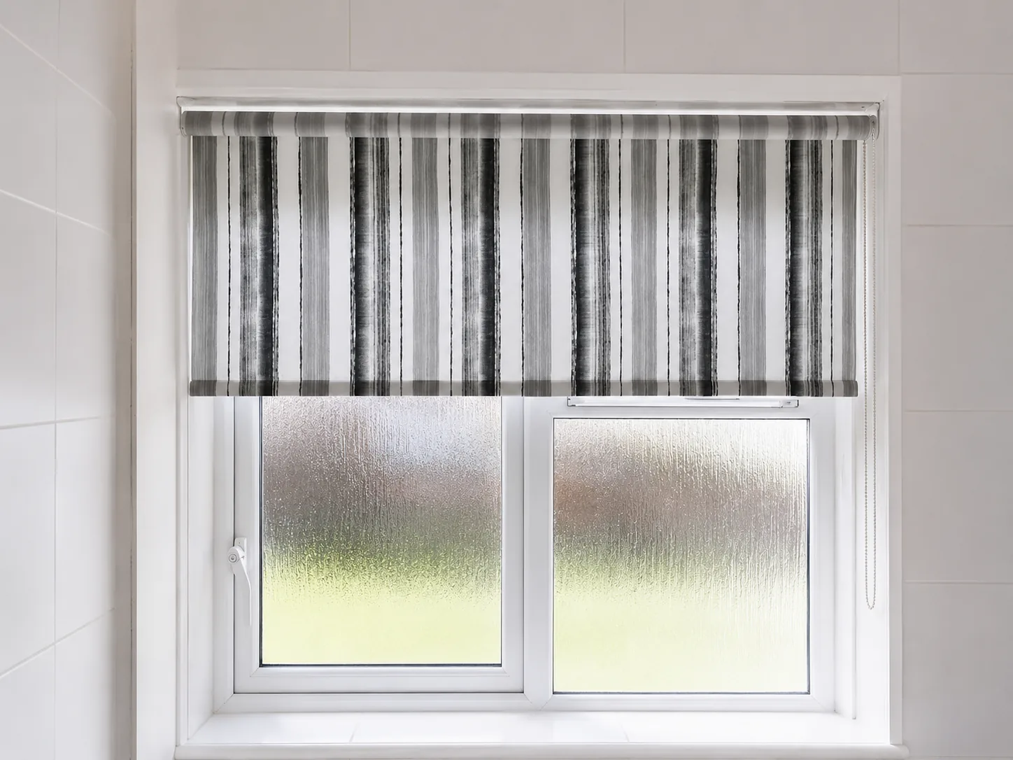 Striped roller blind fitted to a frosted bathroom window