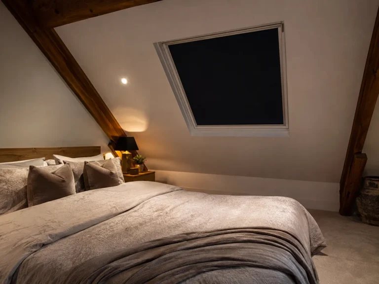 Blackout roof-window blind fitted in a loft bedroom