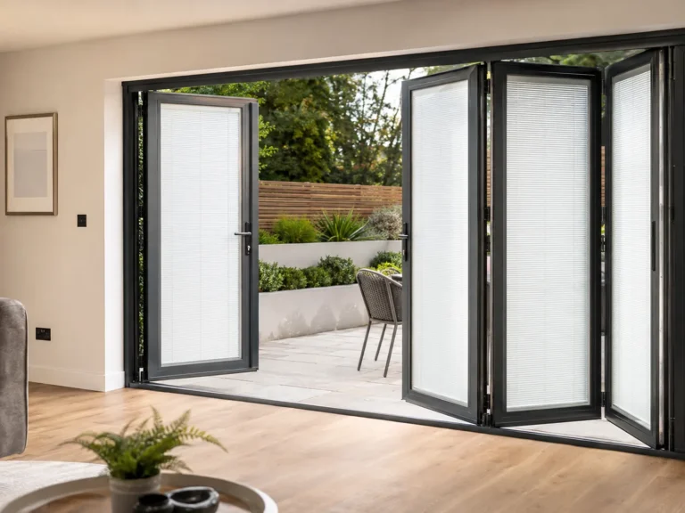 Pleated Perfect Fit blinds fitted to partly opened bi-fold doors