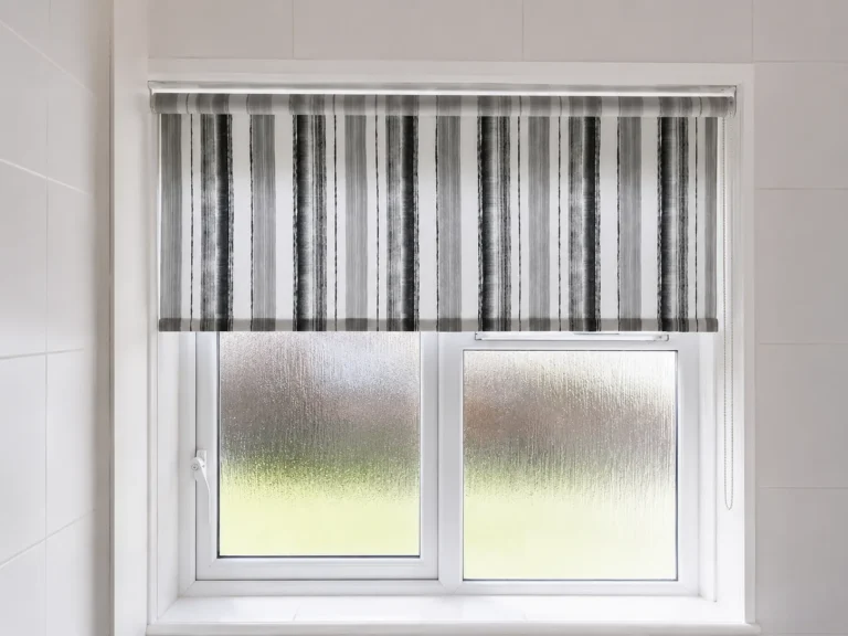 Striped roller blind fitted to a frosted bathroom window